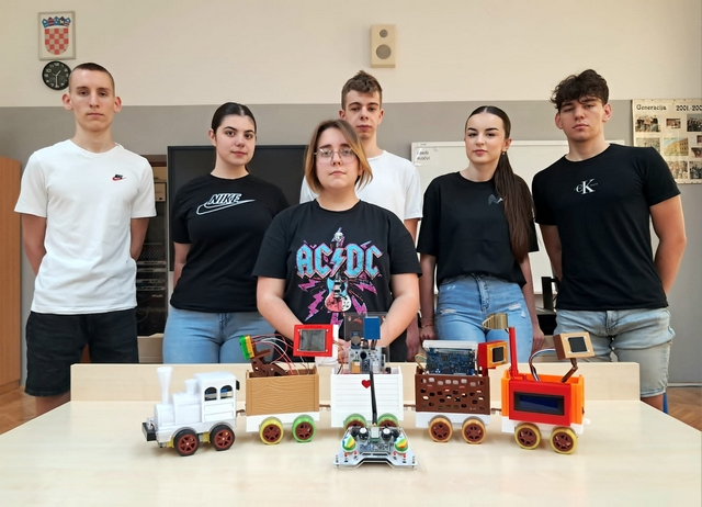 A group of six high school students from Vukovar, Croatia, standing behind their Arduino Express smart train project