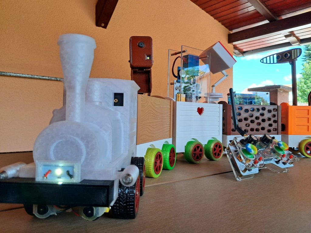 Arduino Express smart train with 3D-printed carriages and STEM learning tools, including a camera, radar and air quality monitor